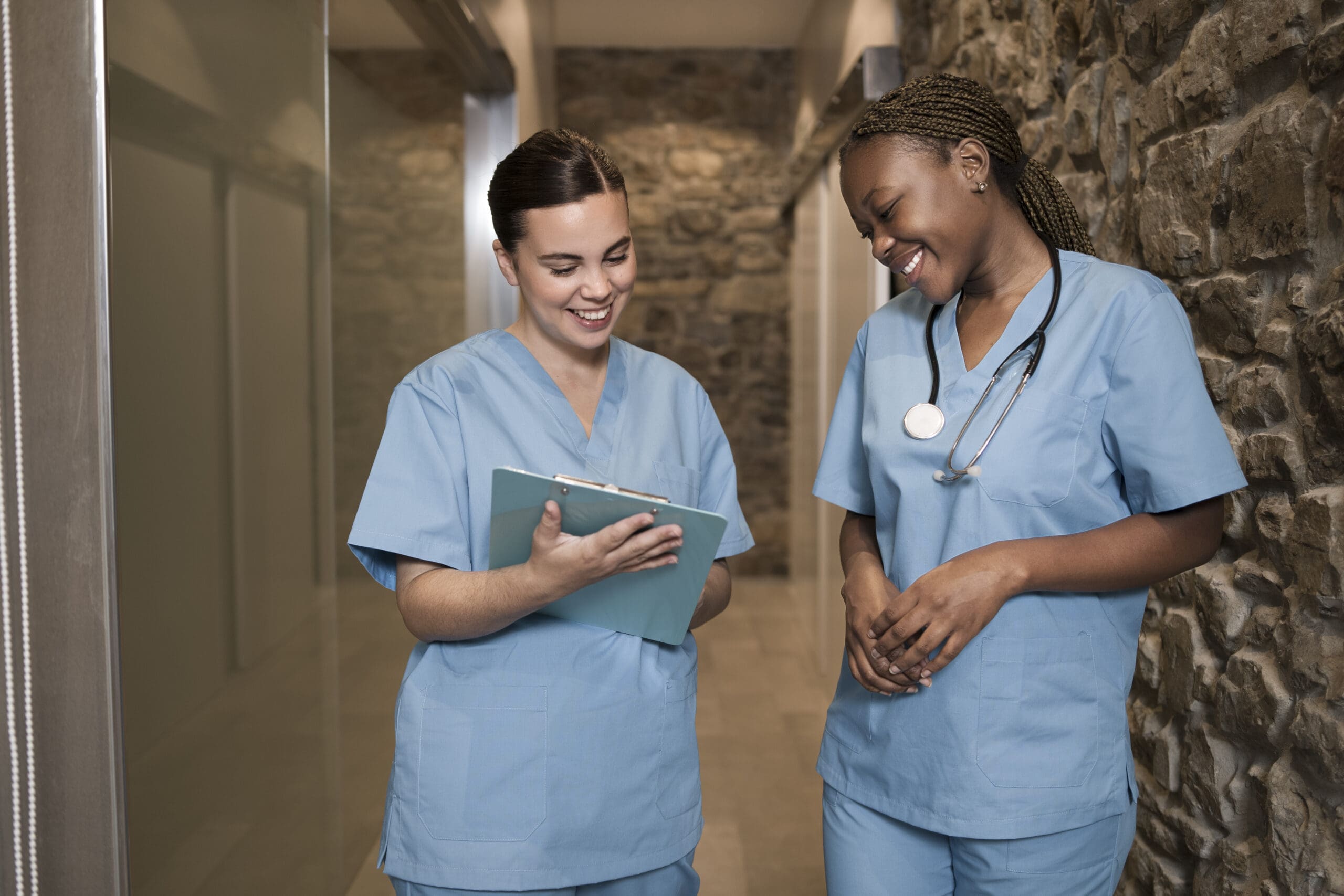 two female nurses talking in a hallway, goes with the blog HCA to IPN Bridging Program BC - Become a Registered Nurse in Canada 